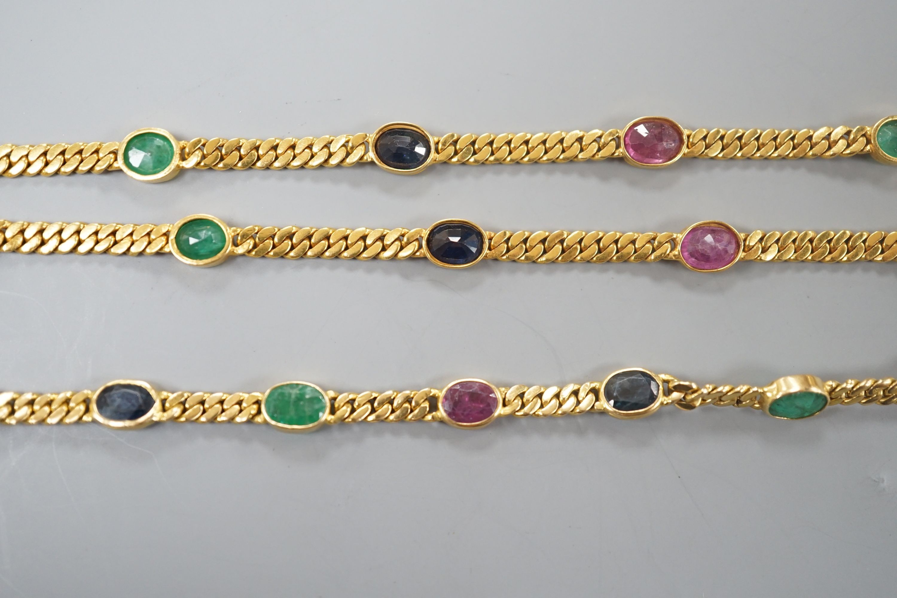 A modern Thai yellow metal and oval multi gem set necklace, 68cm and a similar bracelet, stamped 585, 17.5cm, gross weight 35.4 grams.